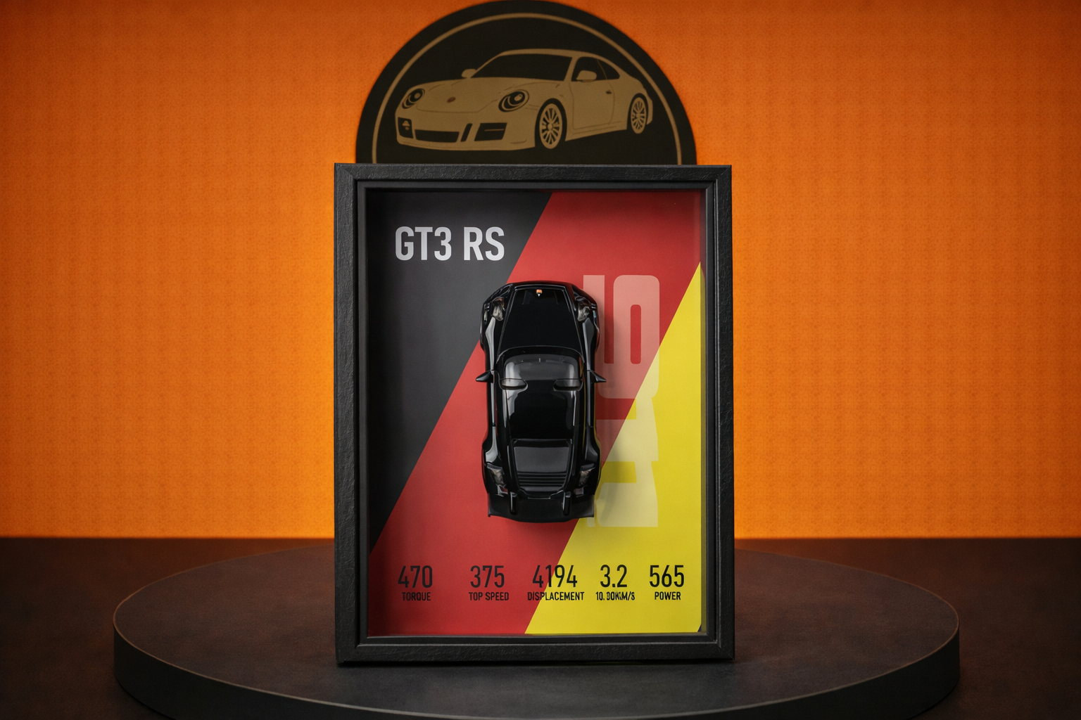 Framed black ScaleCraft model car GT3 RS with performance stats on red, yellow, and black background