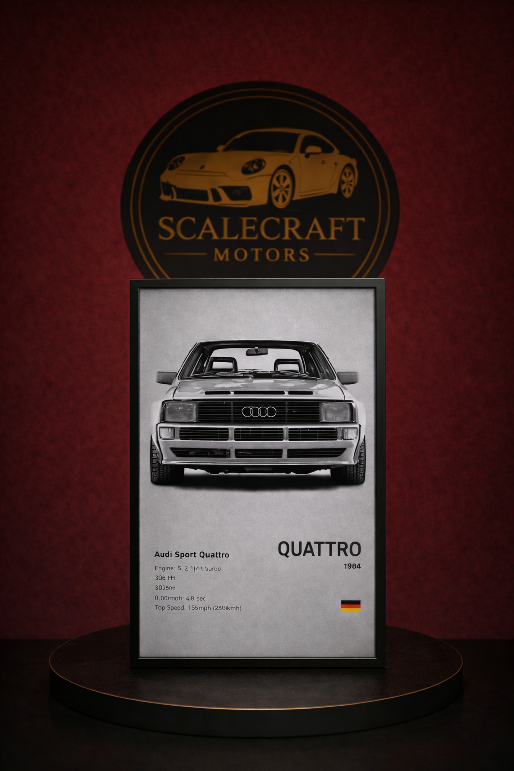 Framed black and white Audi Sport Quattro 1984 poster on round table with ScaleCraft Motors logo backdrop